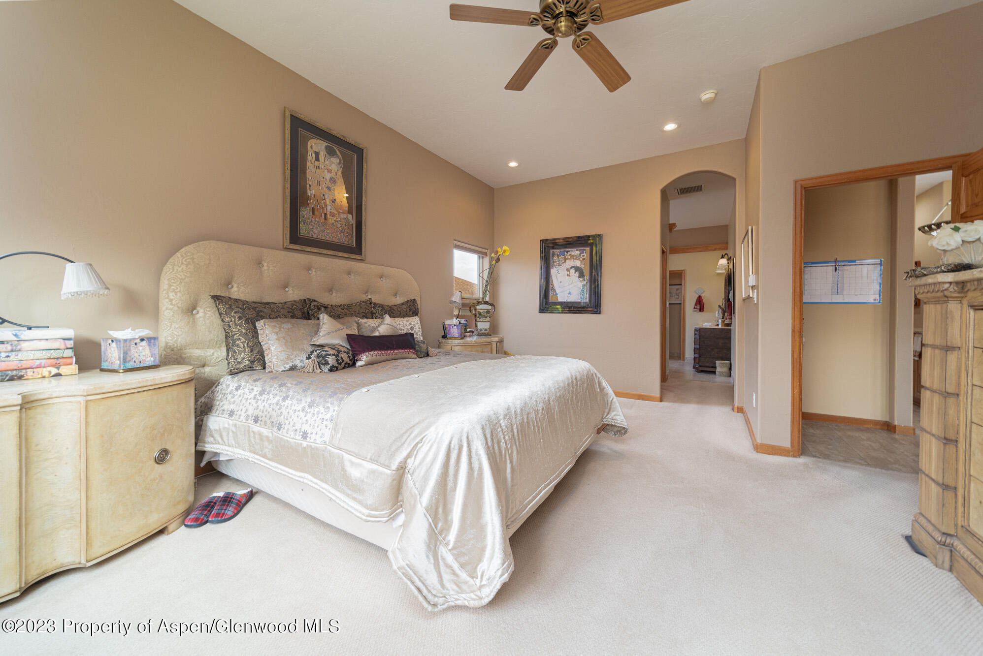 685 Roundup Drive Grand Junction, CO 81507 - Photo 17 of 39 a spacious bedroom with a bed and a chandelier