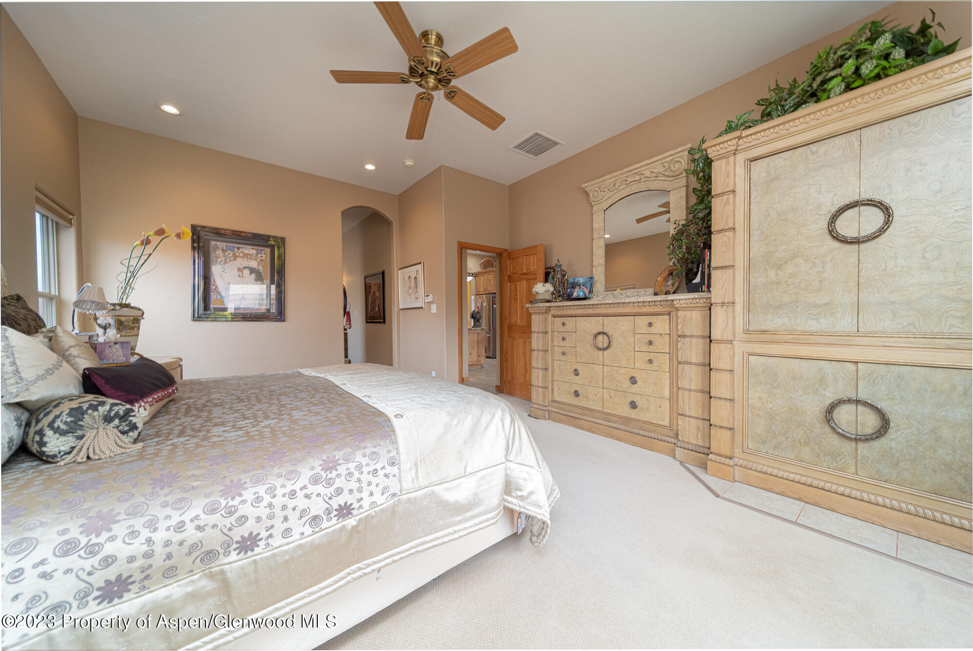 685 Roundup Drive Grand Junction, CO 81507 - Photo 21 of 39 a spacious bedroom with a bed a dresser and potted plants