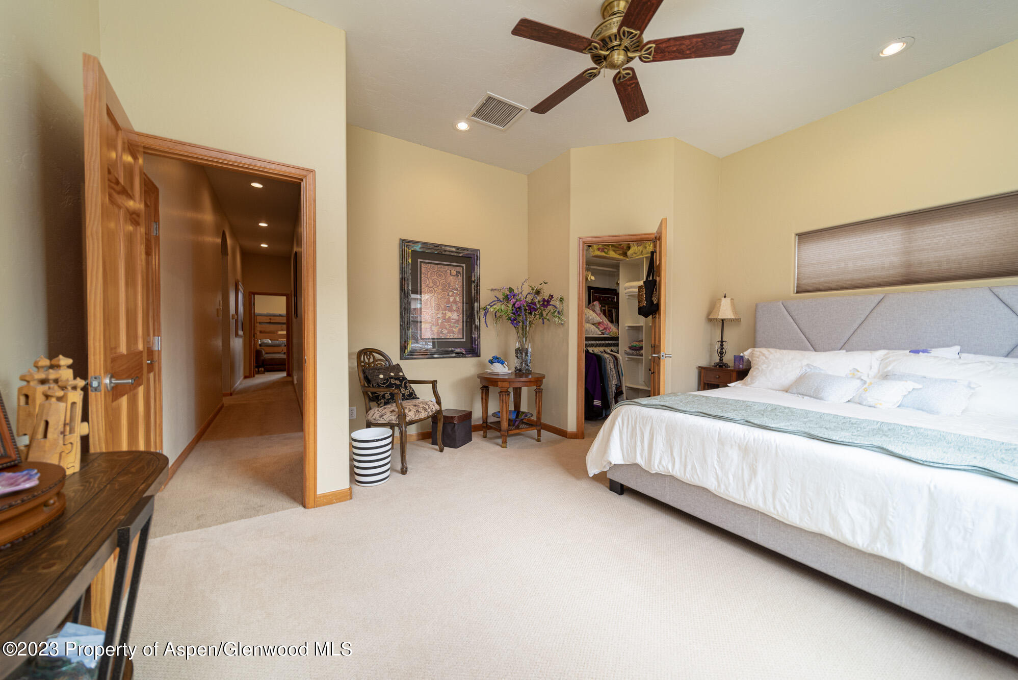 685 Roundup Drive Grand Junction, CO 81507 - Photo 23 of 39 a bedroom with a bed and a chandelier