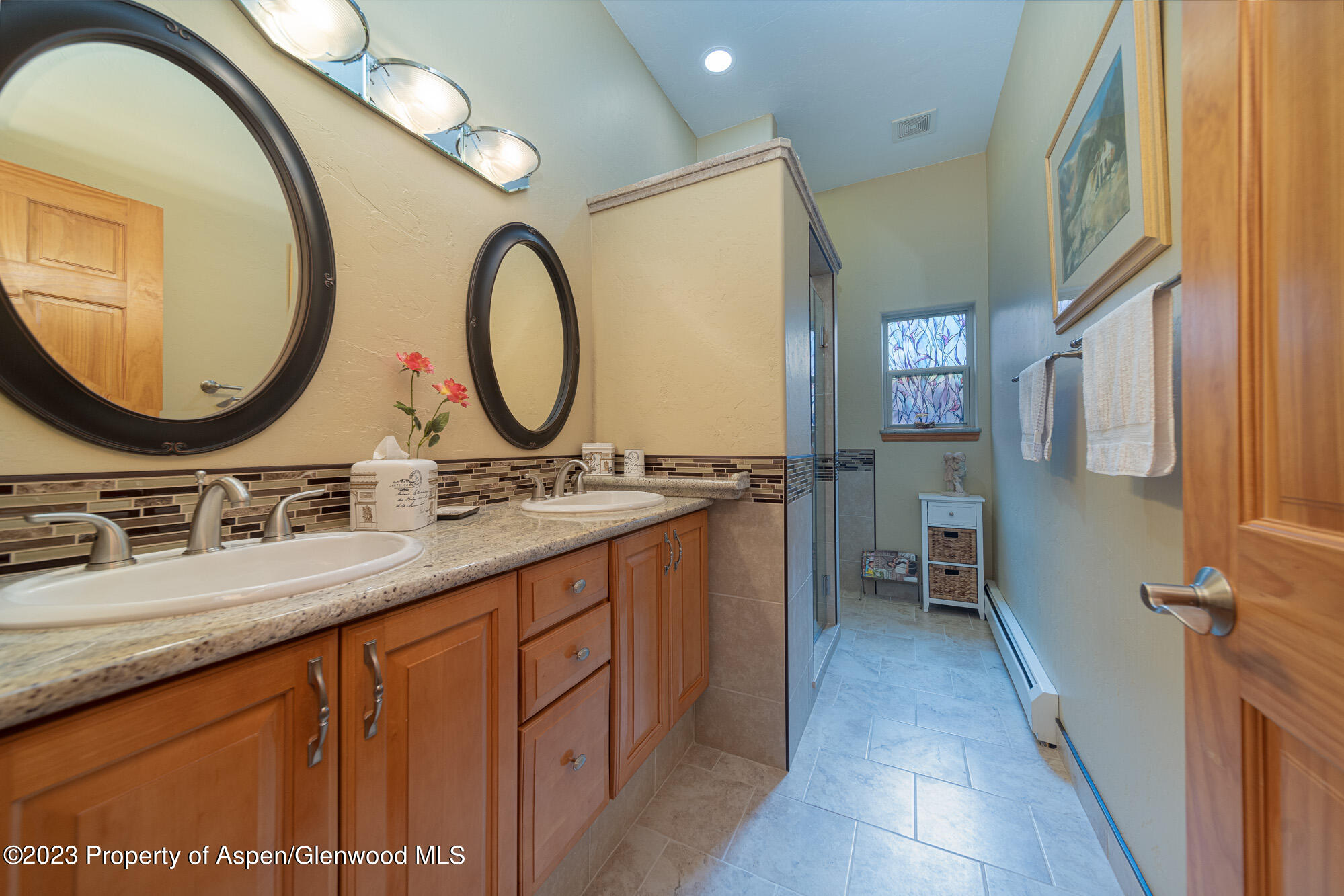 685 Roundup Drive Grand Junction, CO 81507 - Photo 25 of 39 a bathroom with a double vanity sink and a mirror