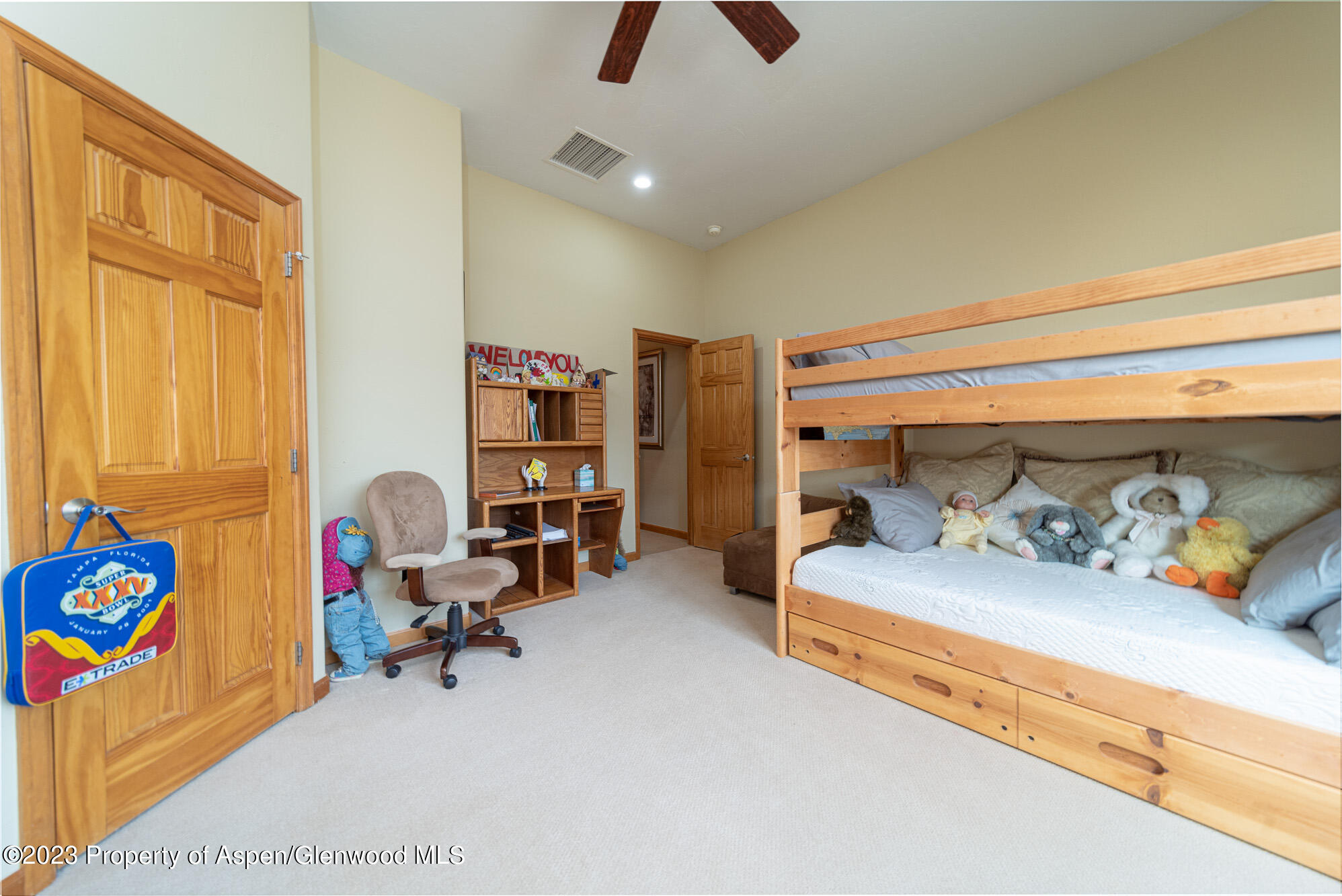 685 Roundup Drive Grand Junction, CO 81507 - Photo 26 of 39 a bedroom with a bed and a chandelier