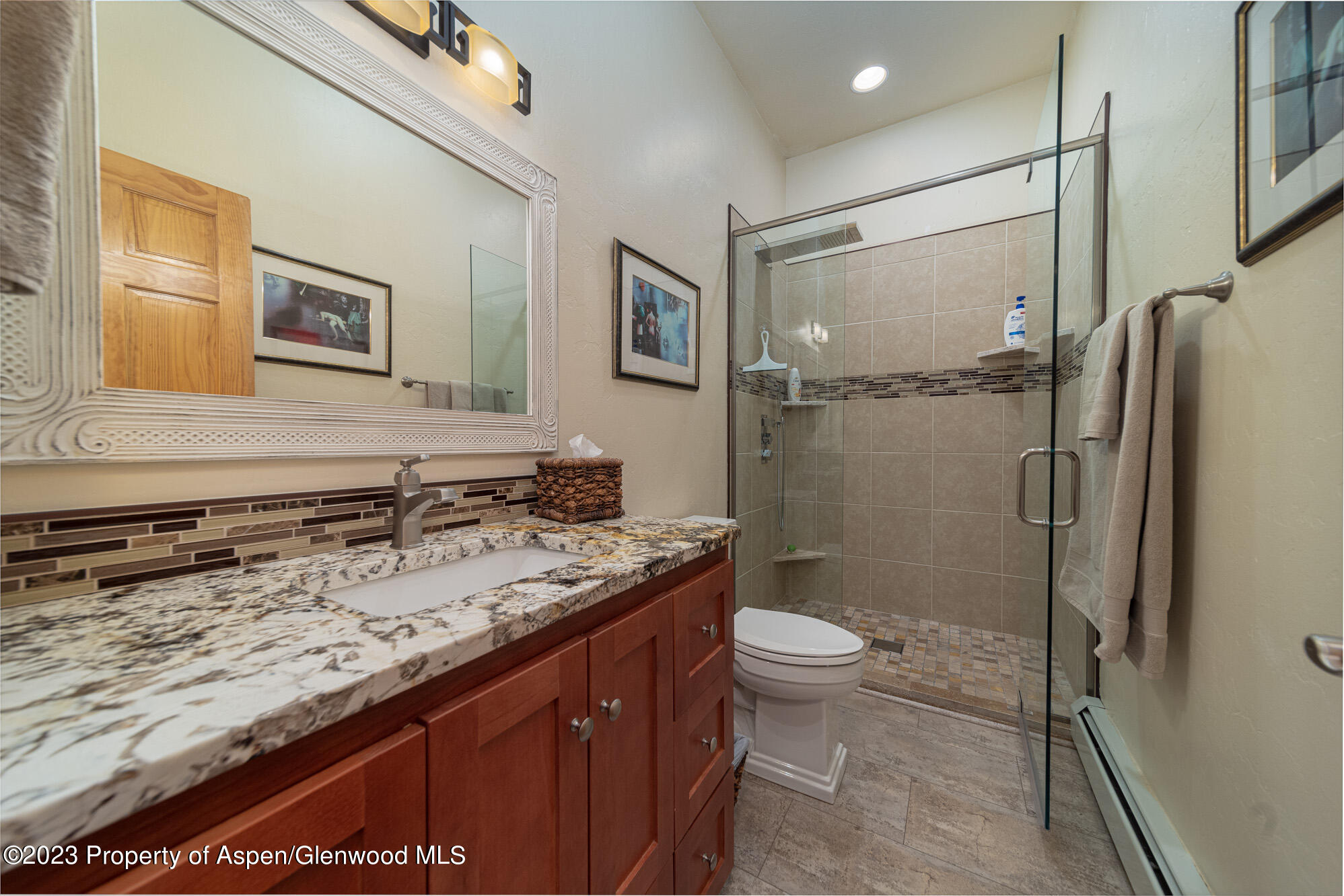 685 Roundup Drive Grand Junction, CO 81507 - Photo 33 of 39 a bathroom with a granite countertop sink toilet and shower