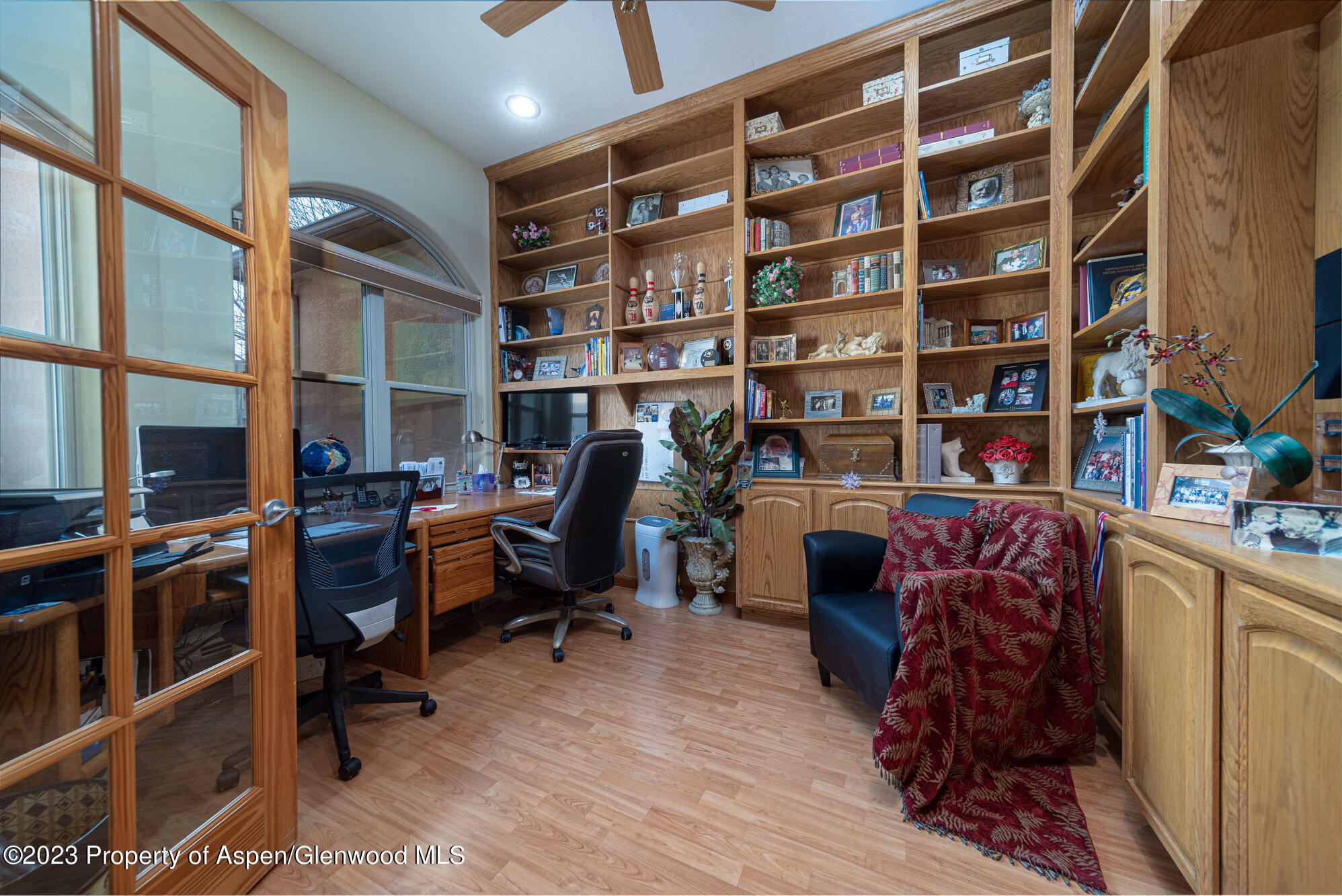 685 Roundup Drive Grand Junction, CO 81507 - Photo 5 of 39 a view of a workspace with furniture and a bookshelf