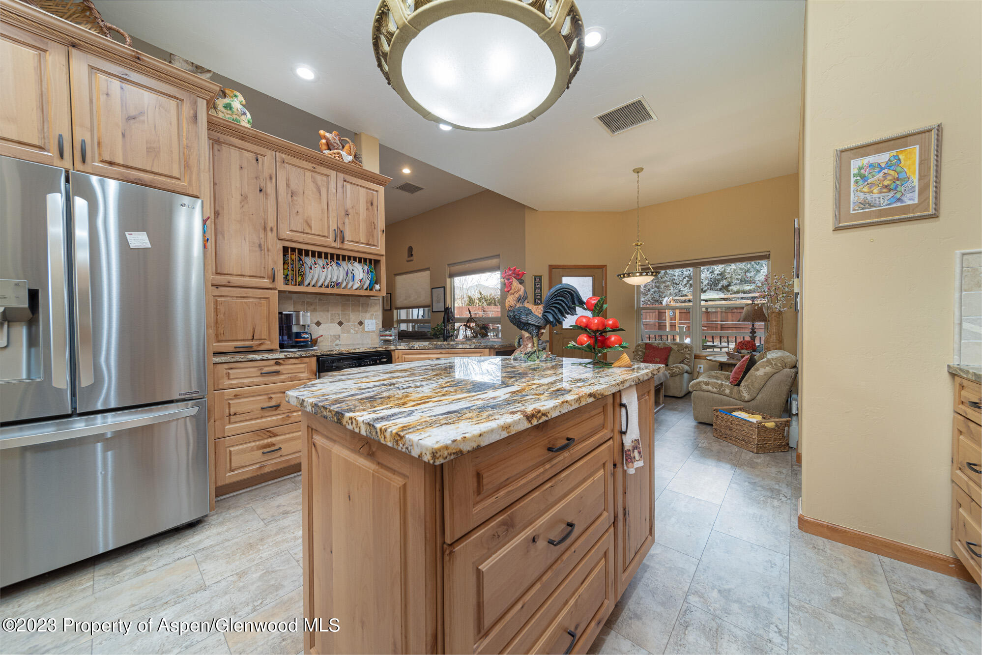 685 Roundup Drive Grand Junction, CO 81507 - Photo 10 of 39 a kitchen with stainless steel appliances granite countertop a stove refrigerator and cabinets