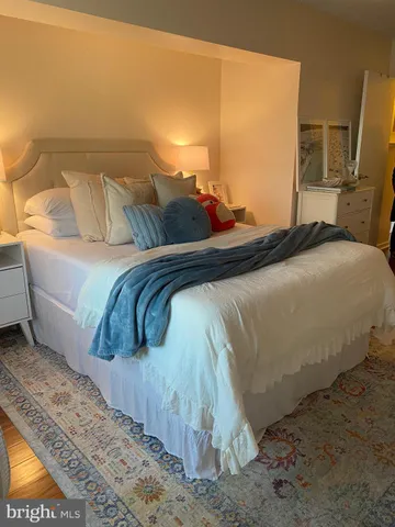 a bedroom with a bed and dresser