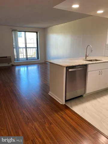 a kitchen with stainless steel appliances a stove a sink and a microwave