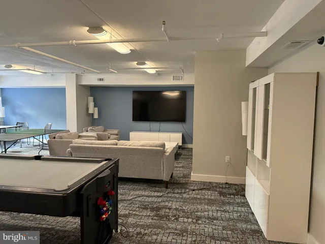a kitchen with stainless steel appliances kitchen island granite countertop a sink and cabinets
