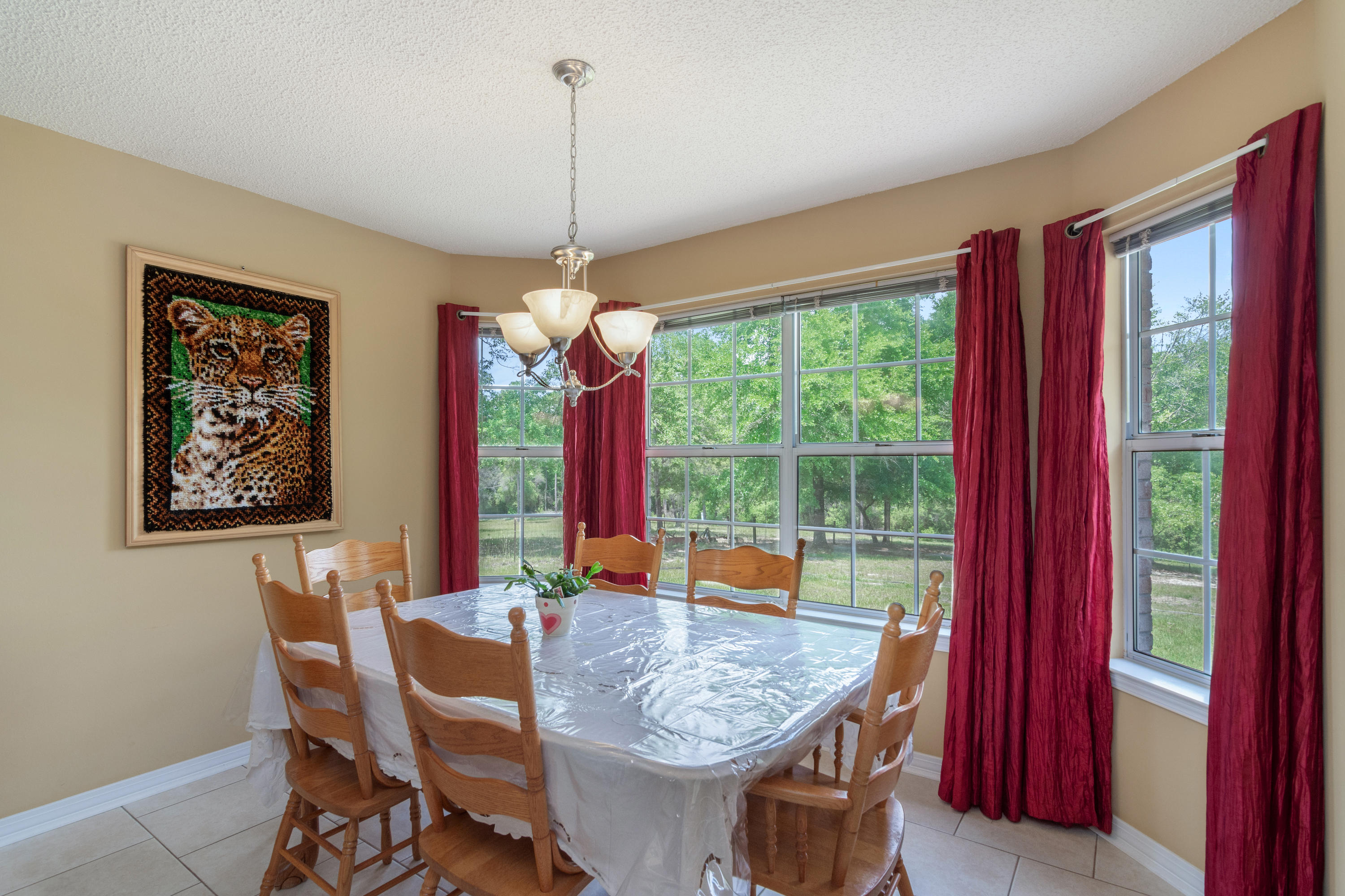 6151 Beasley Road Crestview, FL 32536 - Photo 22 of 49 a dining room with a table or chairs and a wooden floor