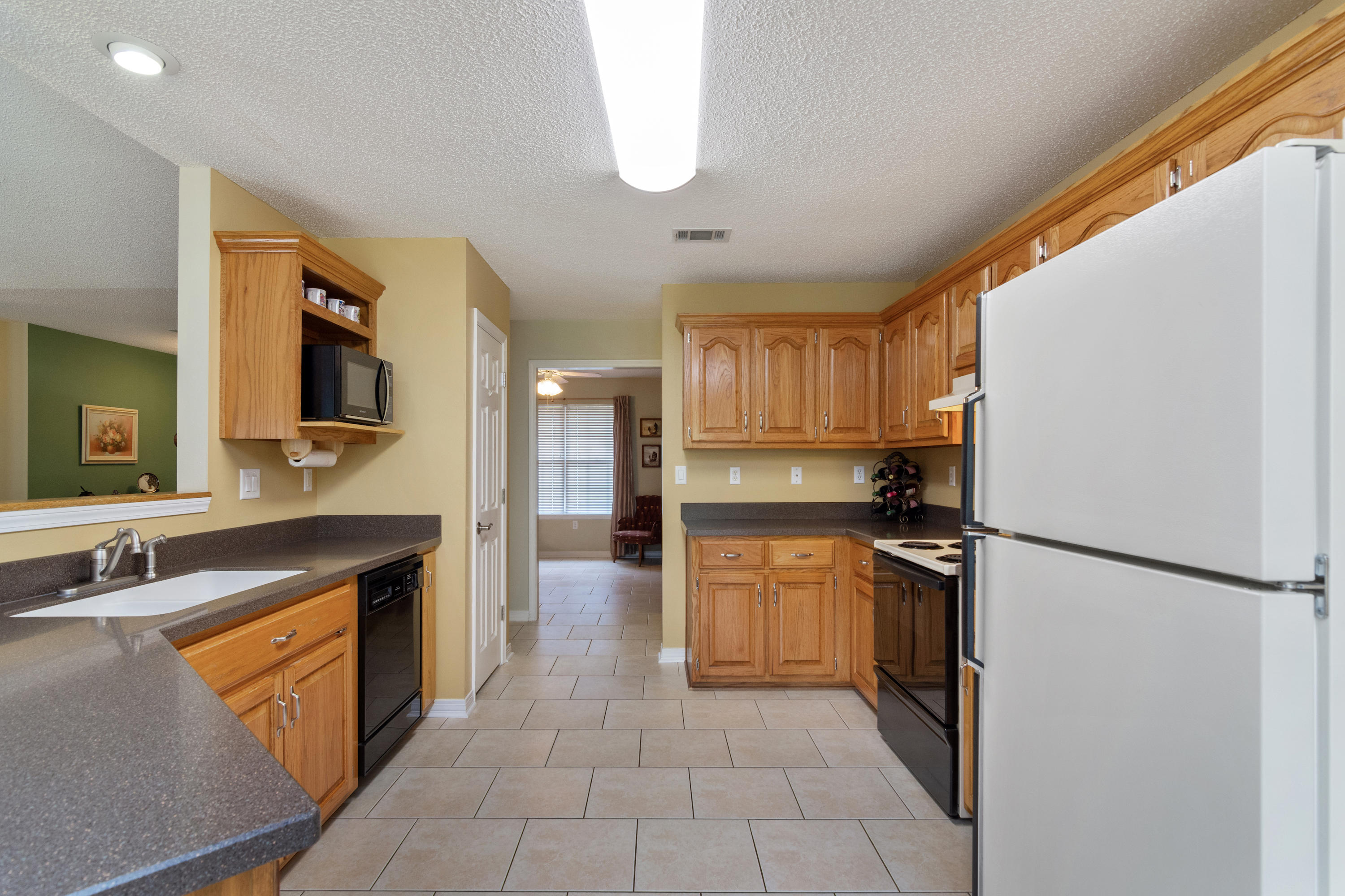 6151 Beasley Road Crestview, FL 32536 - Photo 26 of 49 a large kitchen with cabinets and stainless steel appliances