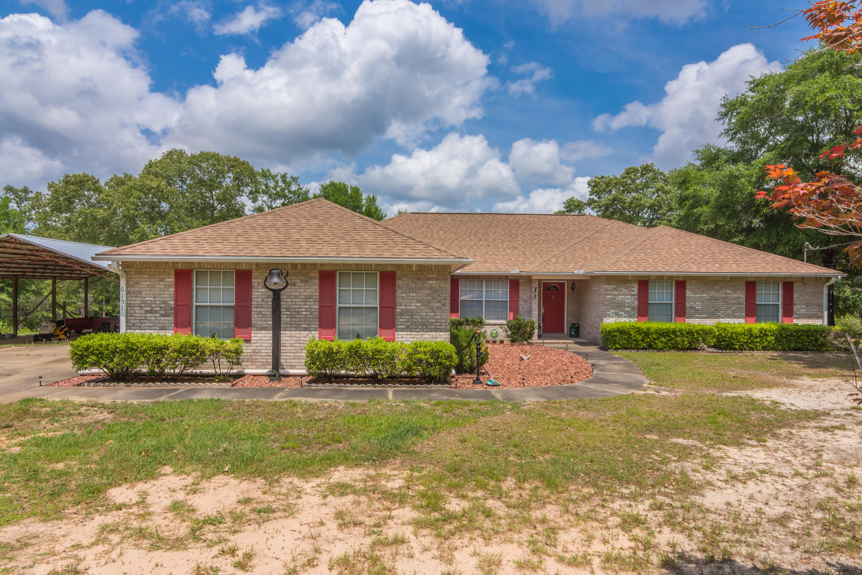 6151 Beasley Road Crestview, FL 32536 - Photo 3 of 49 a front view of a house with a yard