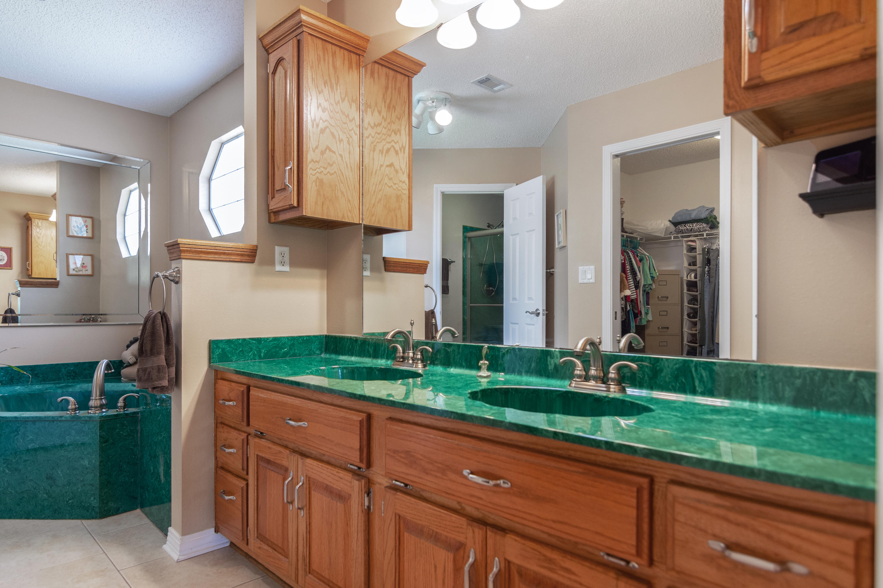 6151 Beasley Road Crestview, FL 32536 - Photo 35 of 49 a bathroom with a sink and a large mirror
