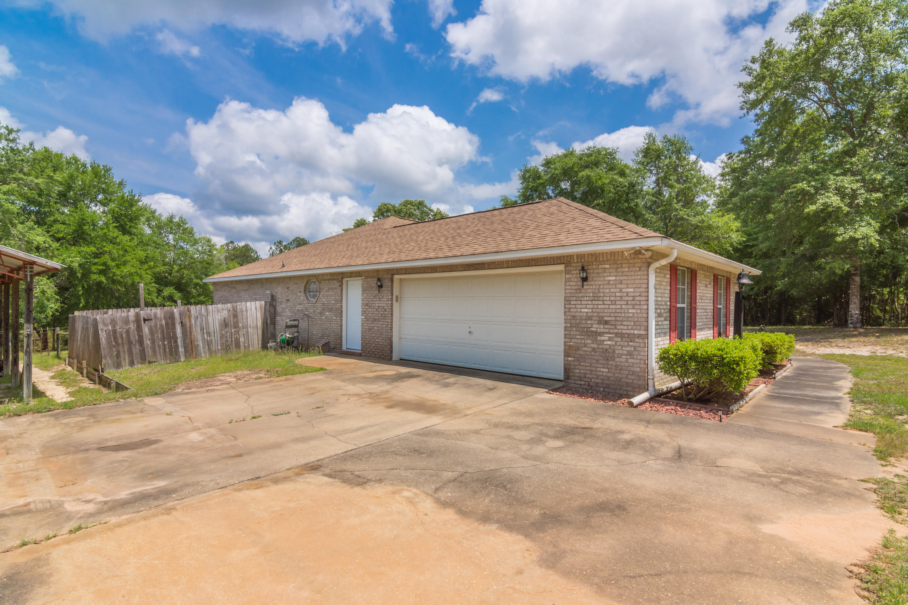 6151 Beasley Road Crestview, FL 32536 - Photo 5 of 49 a front view of house with yard and trees around