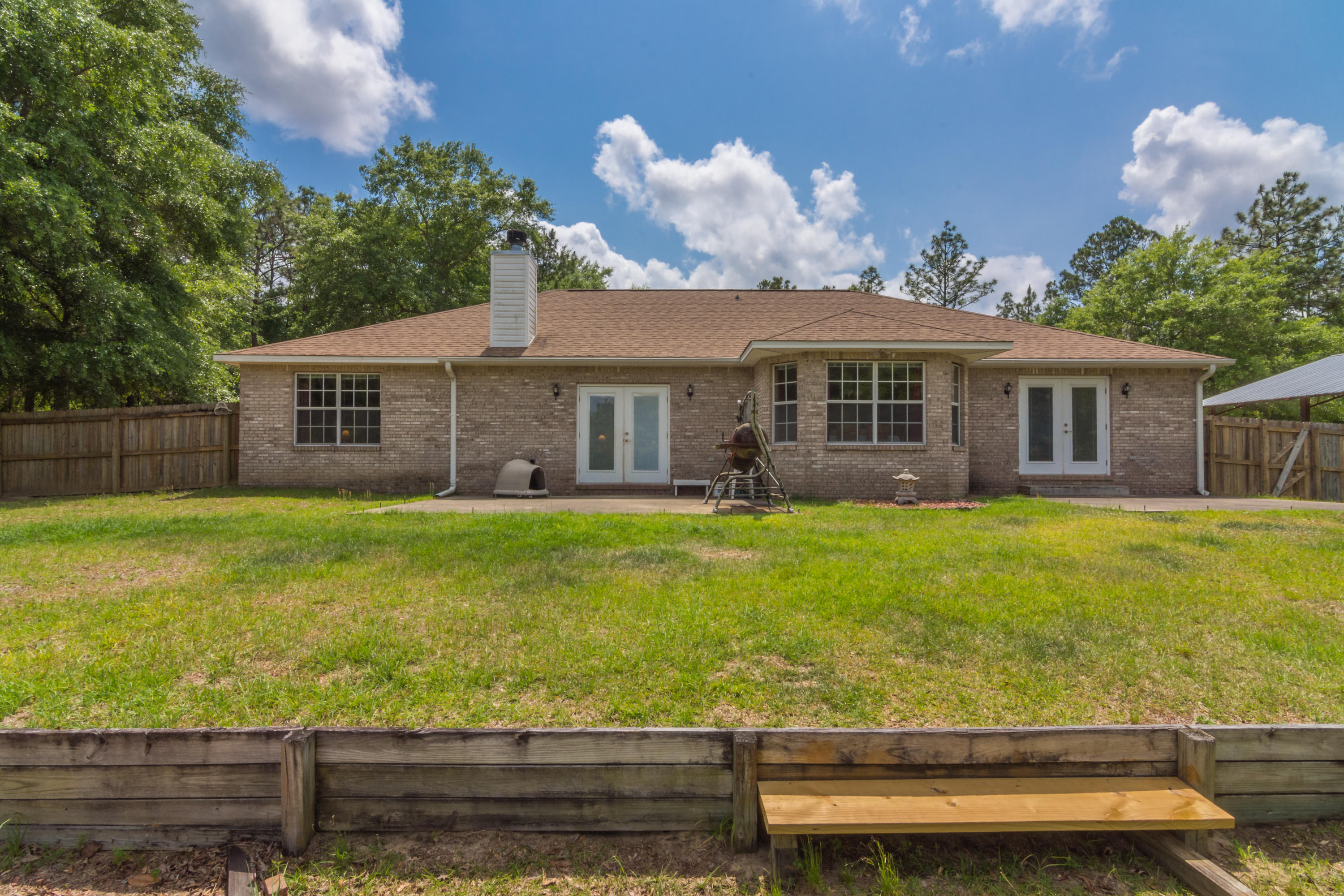 6151 Beasley Road Crestview, FL 32536 - Photo 8 of 49 a front view of a house with a yard table and chairs