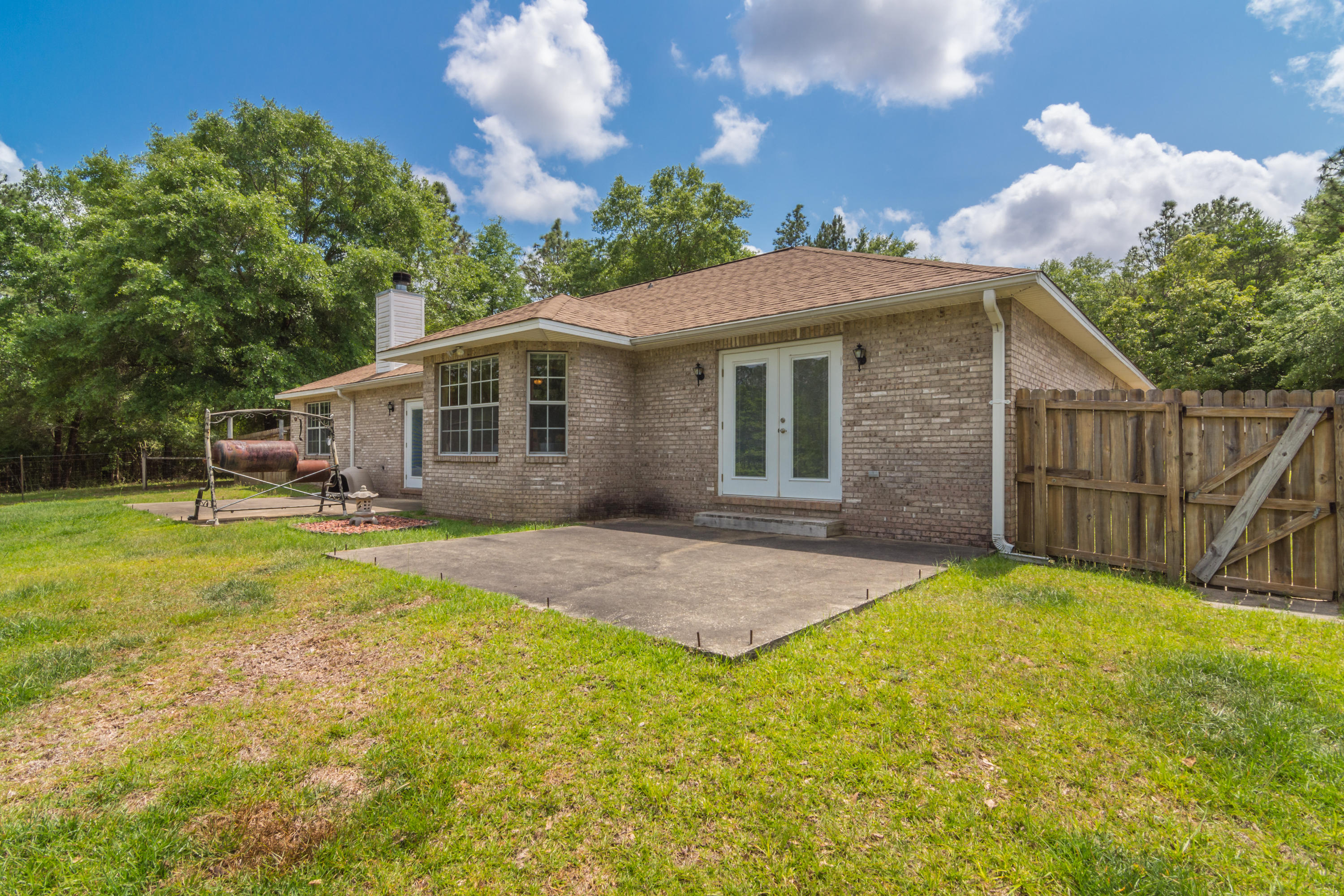 6151 Beasley Road Crestview, FL 32536 - Photo 10 of 49 a view of a house with a yard and potted plants