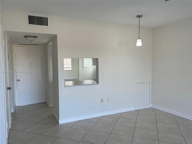a view of a room with wooden floor and cabinet
