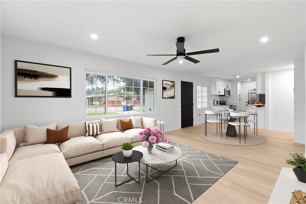 a living room with furniture and kitchen view