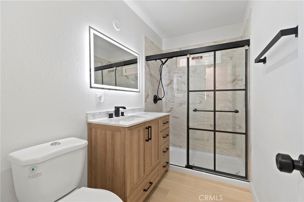 5847 Meadowbrook Lane Riverside, CA 92504 - Photo 13 of 31 a bathroom with a granite countertop sink toilet and mirror