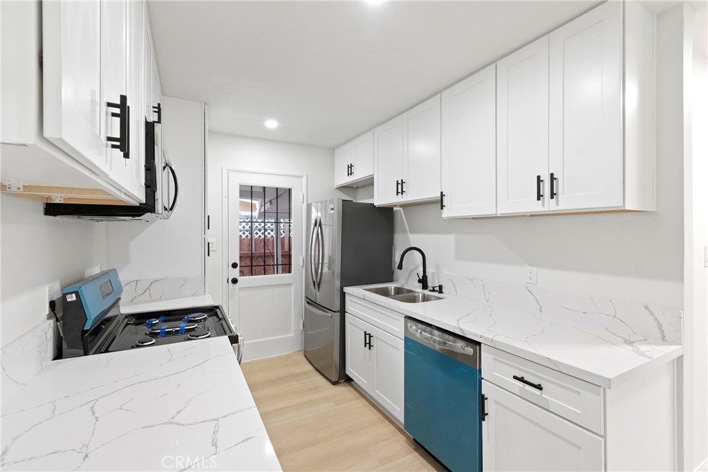 5847 Meadowbrook Lane Riverside, CA 92504 - Photo 9 of 31 a kitchen with a sink a stove and refrigerator