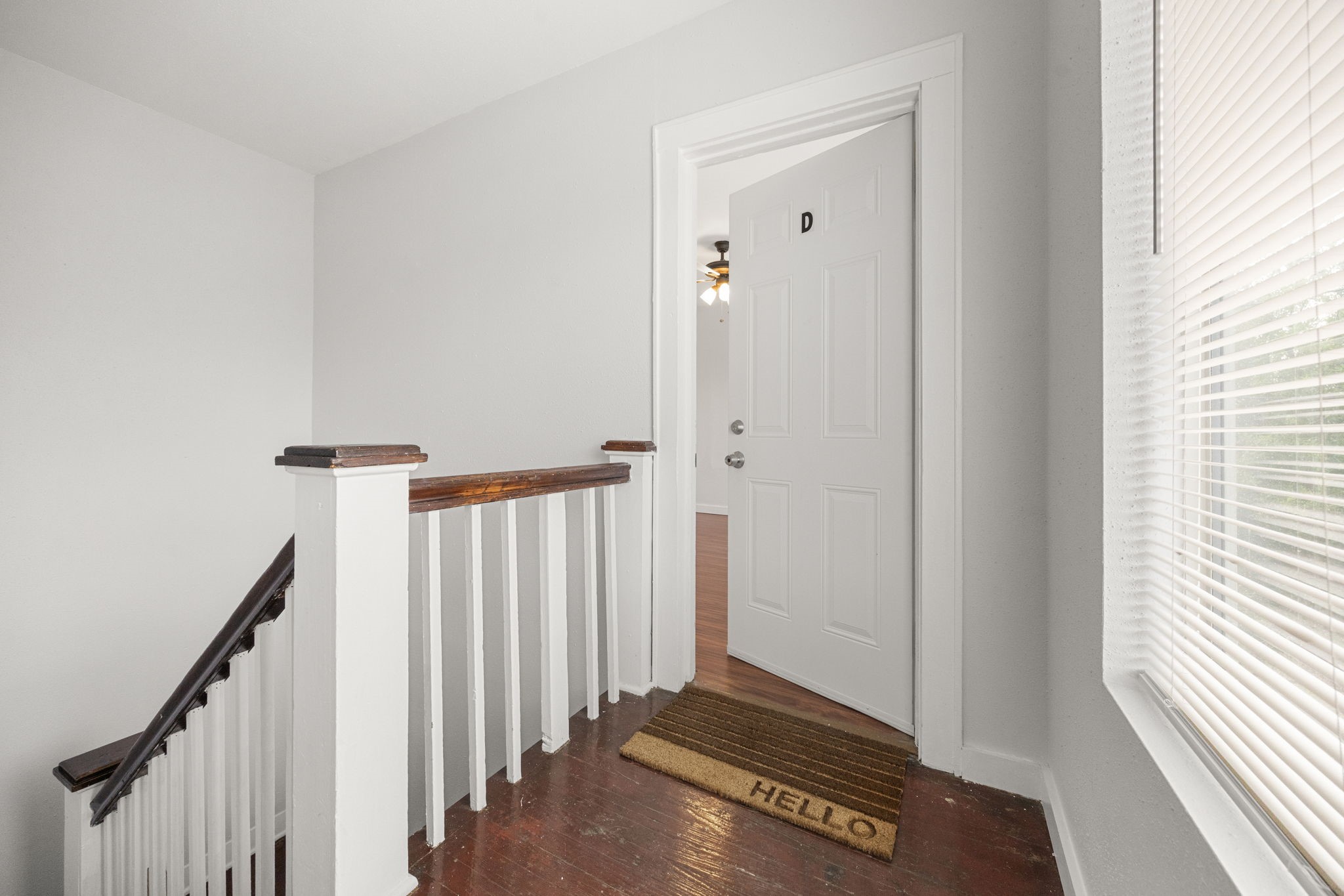 7 Latham Street Houston, TX 77011 - Photo 17 of 23 Upstairs landing with natural light leading to Unit D, offering a private and welcoming entry.