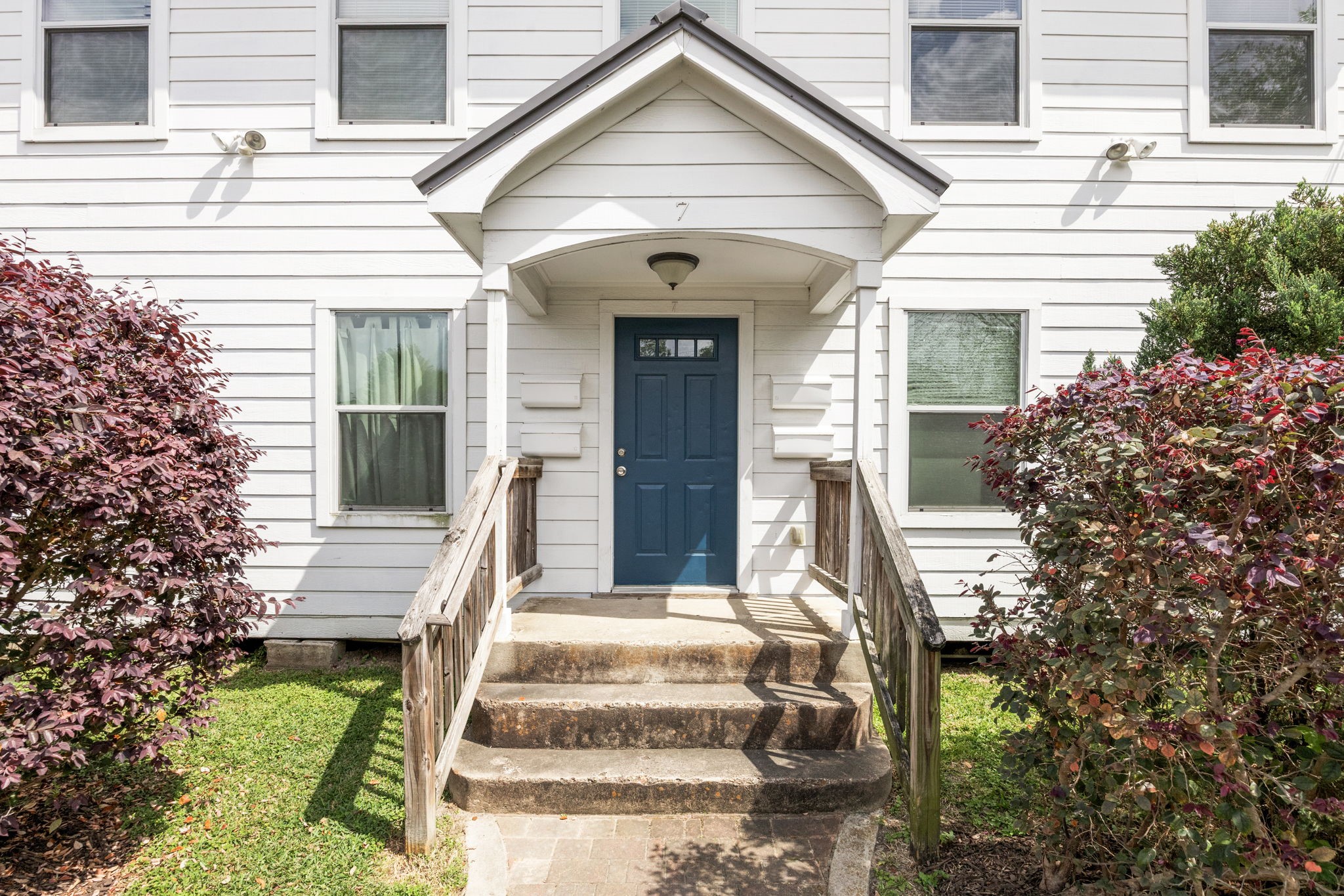 7 Latham Street Houston, TX 77011 - Photo 5 of 23 Inviting covered entry with elevated steps leading to a bold accent front door. Inside you will find two units on first floor and two units on second floor. Unit D is vacant and upstairs.
