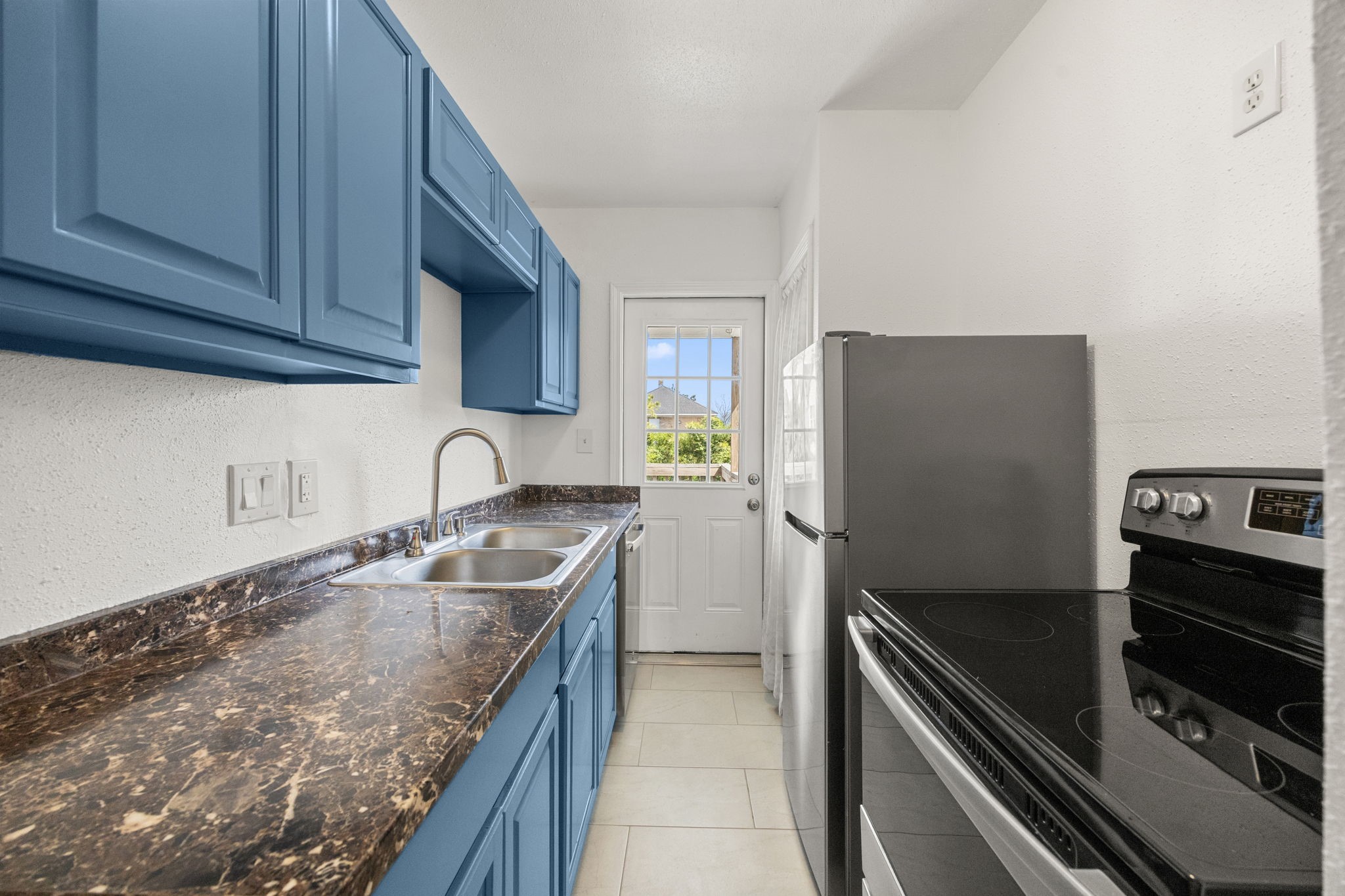 7 Latham Street Houston, TX 77011 - Photo 7 of 23 Functional galley-style kitchen tucked just beyond the main living area for easy access and efficiency.