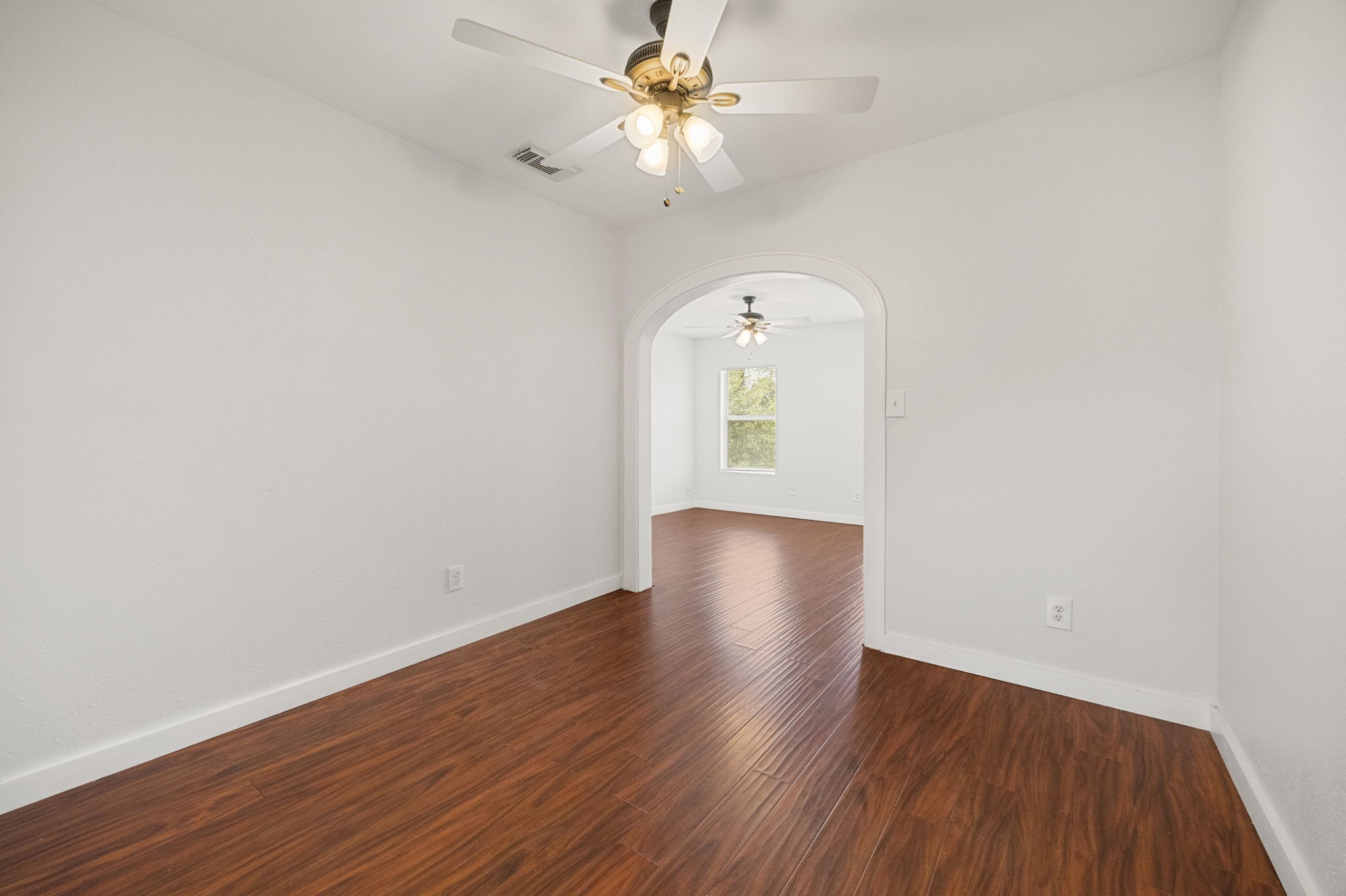 7 Latham Street Houston, TX 77011 - Photo 10 of 23 Dedicated dining area with an arched opening, perfectly situated between the living room and kitchen for easy flow.