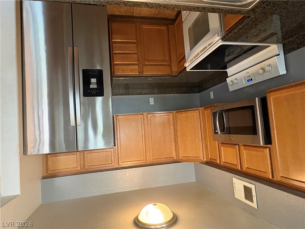 9325 West Desert Inn Road, Unit 123 Las Vegas, NV 89117 - Photo 18 of 36 A well-appointed kitchen showcasing contemporary stainless steel appliances and ample cabinetry.