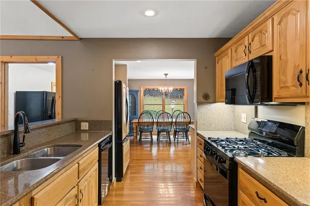 a kitchen with a stove a sink and a microwave