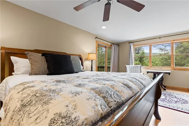 a bedroom with a large bed and a large window