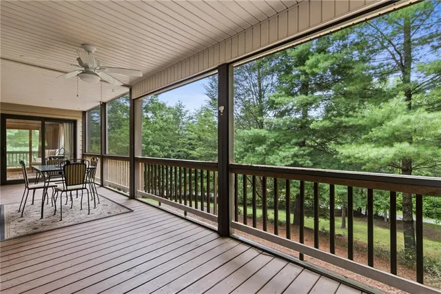 a view of a balcony with furniture and wooden floor