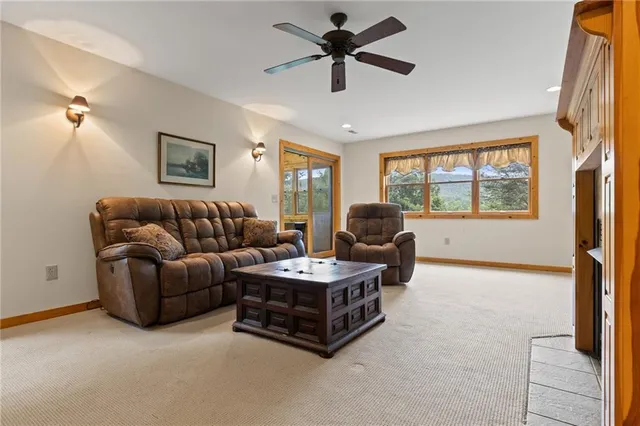 a living room with furniture a ceiling fan and a window
