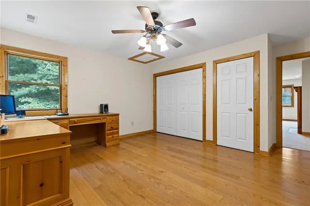 a view of a workspace with furniture and a window