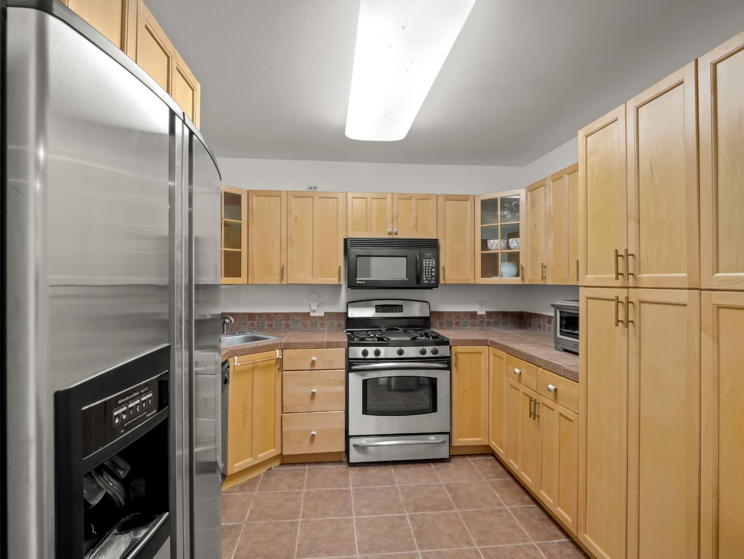 17113 Mark Road Madera, CA 93636 - Photo 81 of 99 a kitchen with cabinets stainless steel appliances and a window