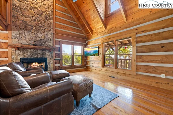 a living room with furniture and a table with wooden floor