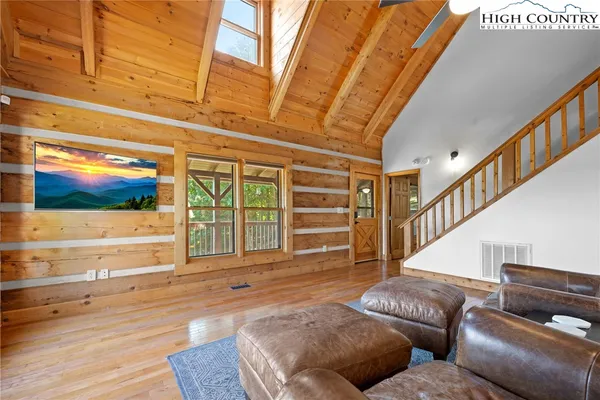 a living room with furniture wooden floor and a fireplace