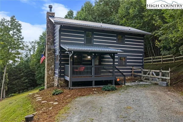 a backyard of a house with wooden floor and fence