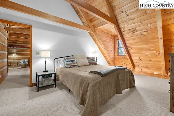 a bedroom with a bed and a large window with the outer view