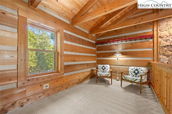 a bed sitting in a spacious bedroom next to a window