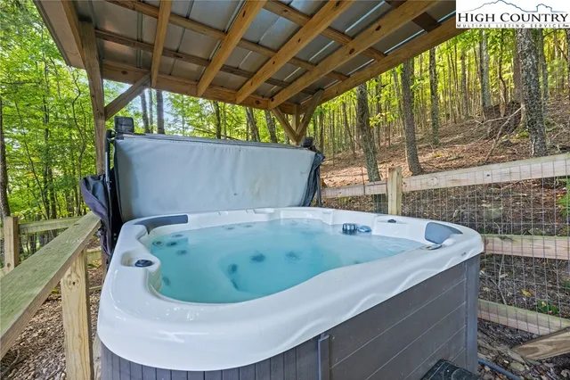 an aerial view of a house with swimming pool next to a big yard