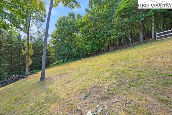 an aerial view of a house with swimming pool next to a big yard