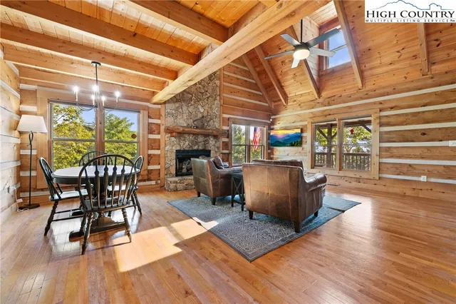 a living room with furniture and a table with wooden floor