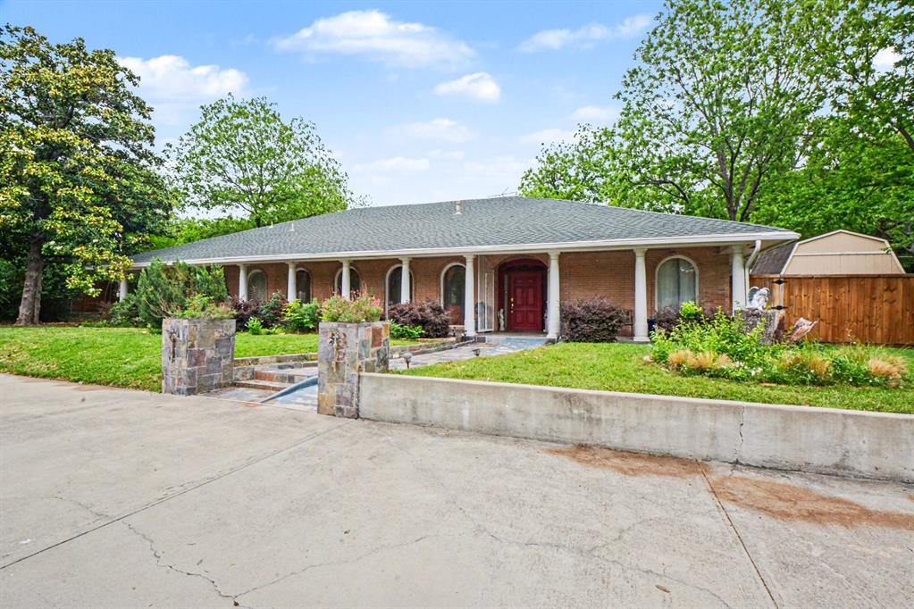 a front view of house with yard and green space
