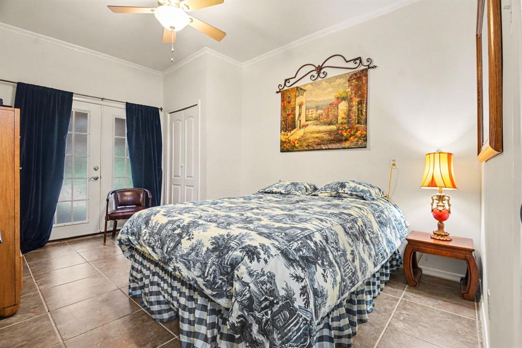 14140 Hillcrest Road Dallas, TX 75254 - Photo 13 of 29 a bedroom with a bed and a painting on the wall