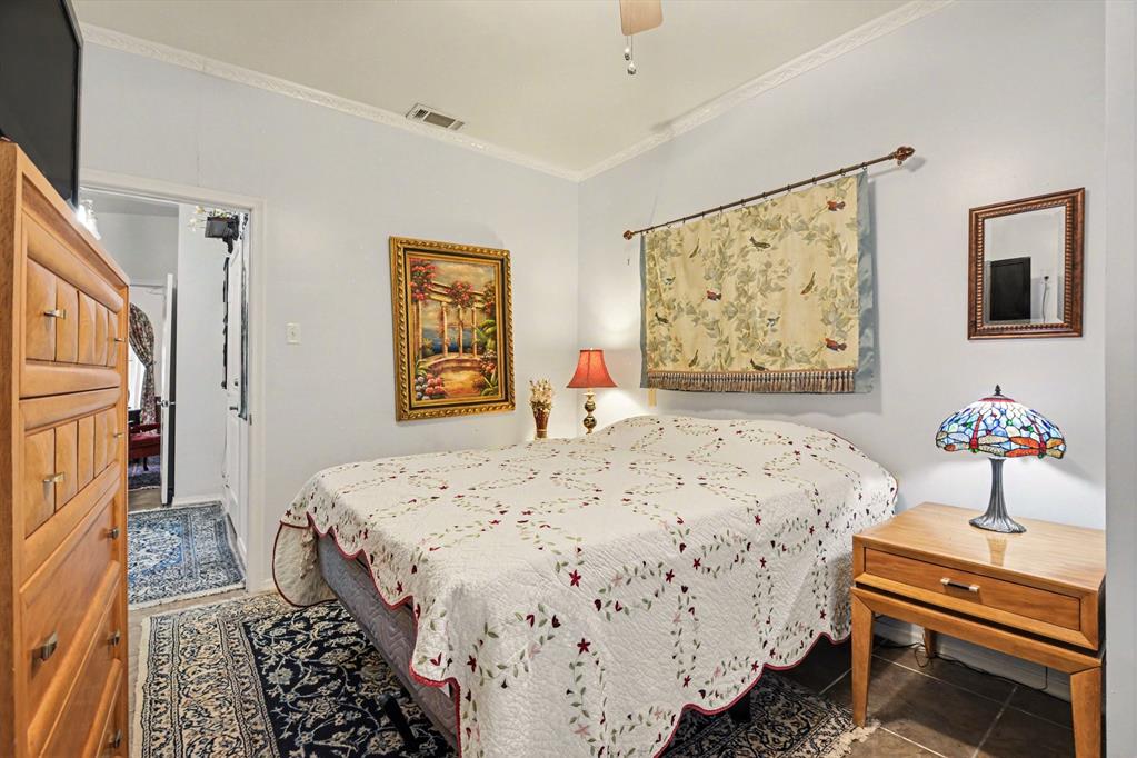 14140 Hillcrest Road Dallas, TX 75254 - Photo 17 of 29 a bedroom with bed and wooden floor