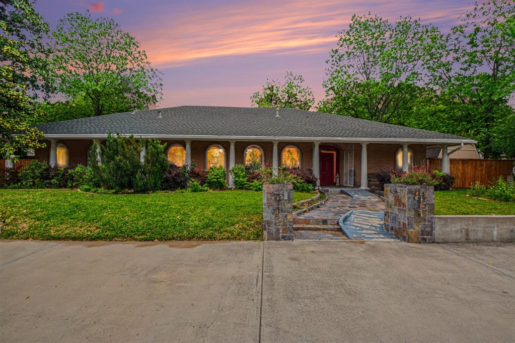 14140 Hillcrest Road Dallas, TX 75254 - Photo 29 of 29 a front view of a house with a yard and garage