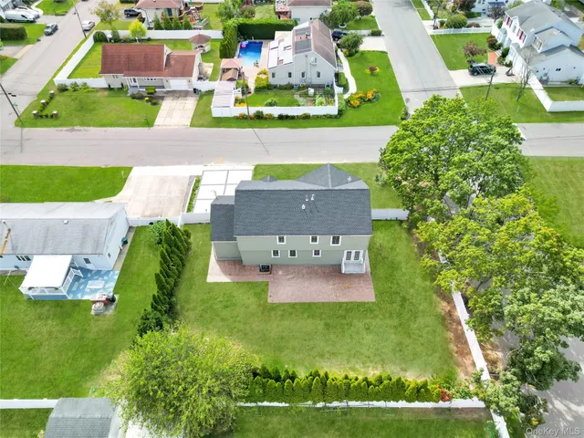 an aerial view of a house with a garden and swimming pool