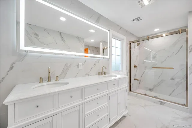 a bathroom with a shower sink and mirror