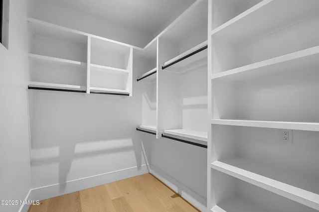 a view of walk in closet with empty racks