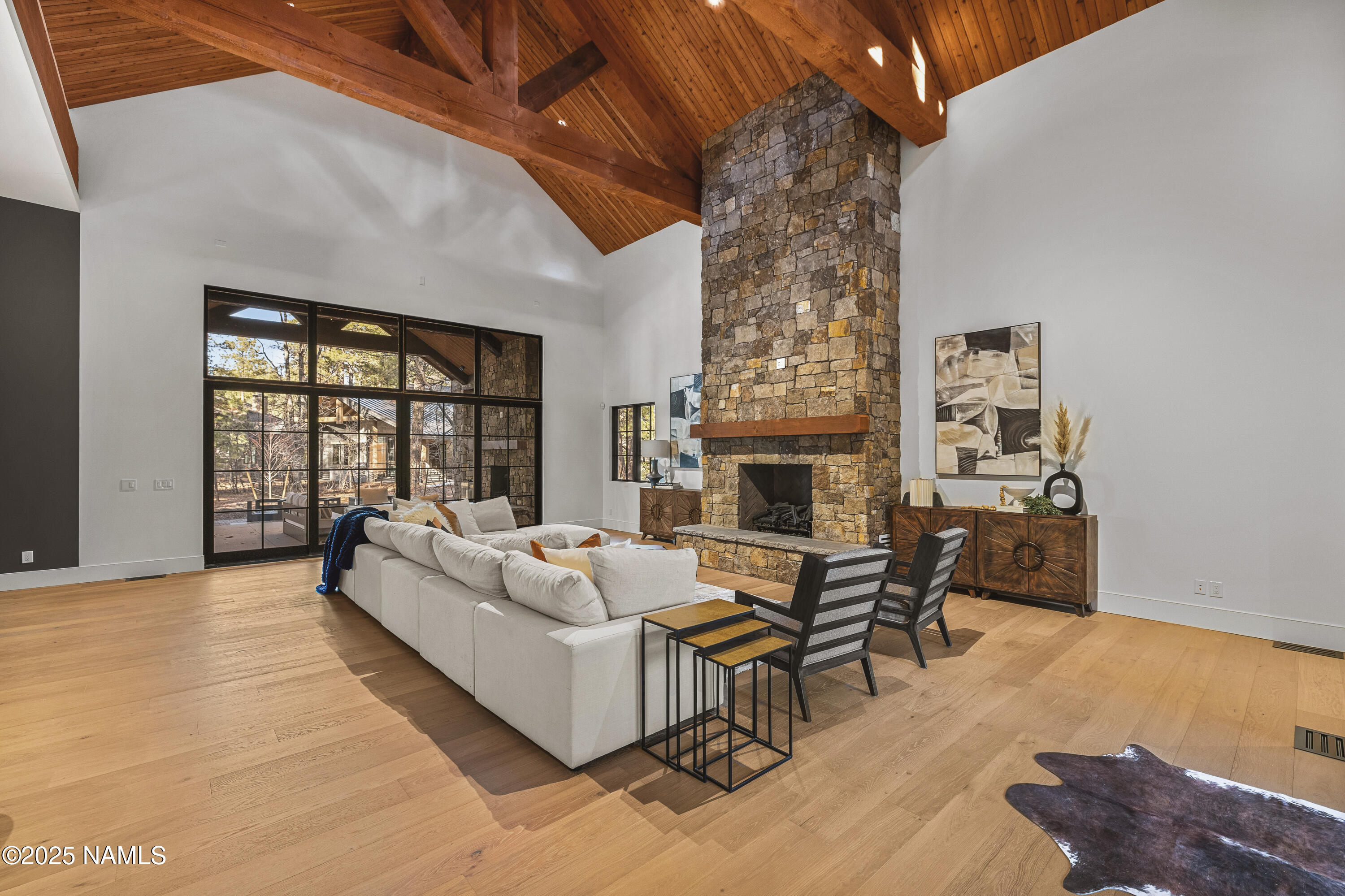 2732 Lindberg Flagstaff, AZ 86005 - Photo 4 of 56 a living room with furniture a fireplace and a floor to ceiling window