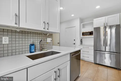 a kitchen with a sink cabinets and window
